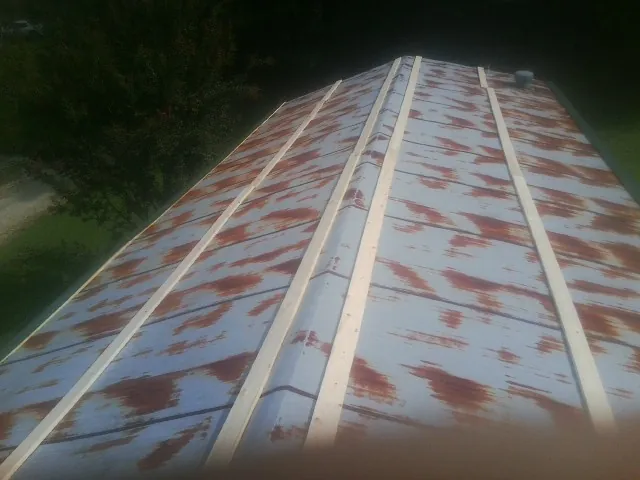 Rusted metal roof panels with new wood purlins before replacement — Storm Damage Roof Repair in Maiden by Roofing Brothers