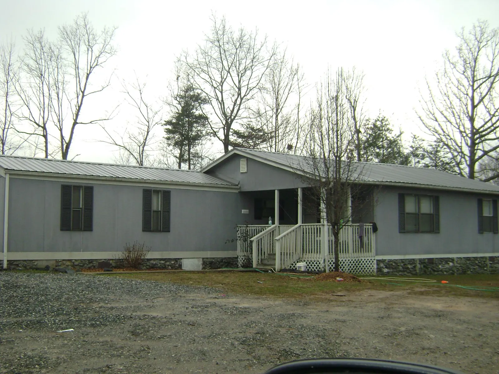 Metal roof over a manufactured home with a covered front porch in Maiden